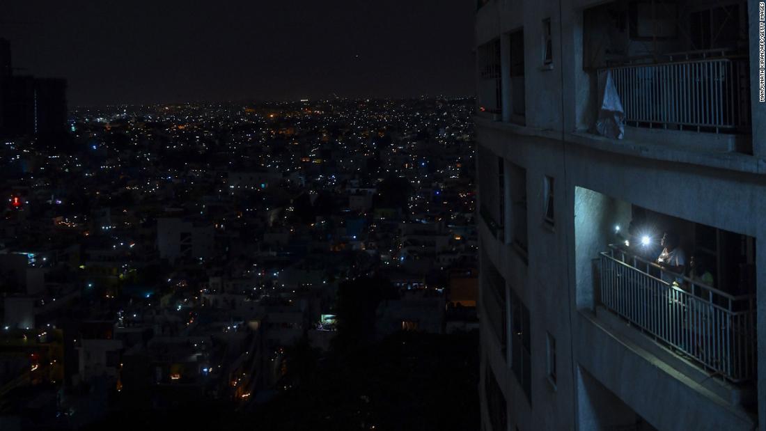 People shine lights from their balcony during a &lt;a href=&quot;https://www.cnn.com/2020/04/05/world/india-coronavirus-candlelight-vigil/index.html&quot; target=&quot;_blank&quot;&gt;nationwide candlelight vigil&lt;/a&gt; in Bangalore, India, on April 5.